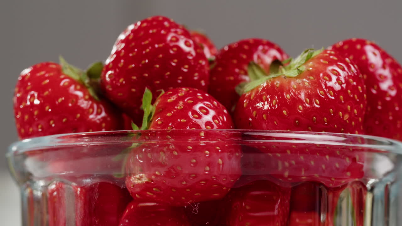 Fresh Red Strawberries Rotating in a Glass Bowl