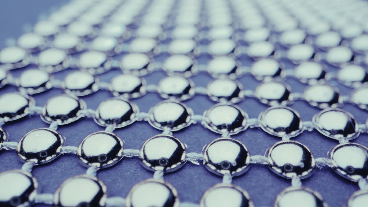 Close-up view of a silver beaded grid pattern