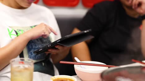 people using a tablet to order food