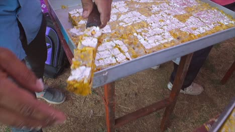 indian sweets making and swees placed empty rectangle tray closeup view