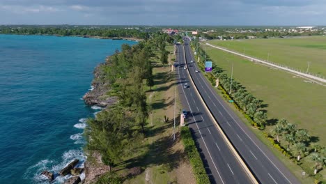 aerial view of cars driving in the road near the las americas international airport in la caleta, boca chica, santo domingo, dominican republic