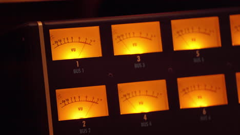 vu meters at a recording studio with the needles indicating the sound intensity - isolated close up