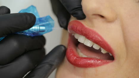 Permanent Makeup On Lips. Cosmetologist applying permanent make-up on lips