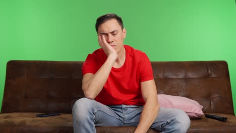 sad and depressed man trying to watch a movie
