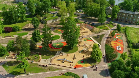 colorful park with kids playground, aerial drone orbit view