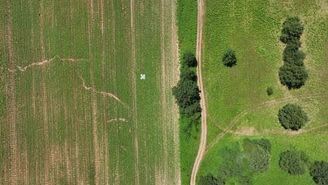 aerial top down drone surveying farmland with multispectral sensors