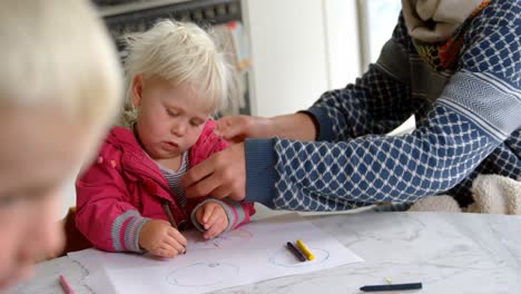 Father-helping-his-daughter-in-drawing-at-home-4k