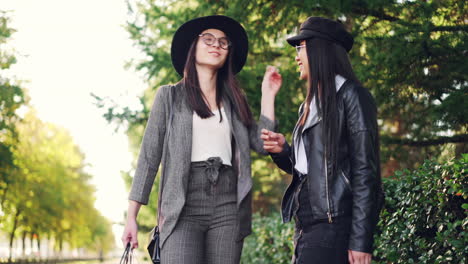 two women shopping and talking outdoors