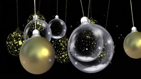 animation of christmas baubles dangling over snow falling on black background