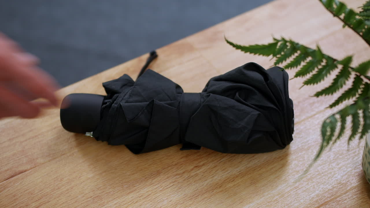 본사를 떠날 때 테이블 책상에서 우산을 집는 남자