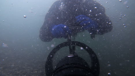 bubbles galore as scooter pulls tech diver in river under waterfall