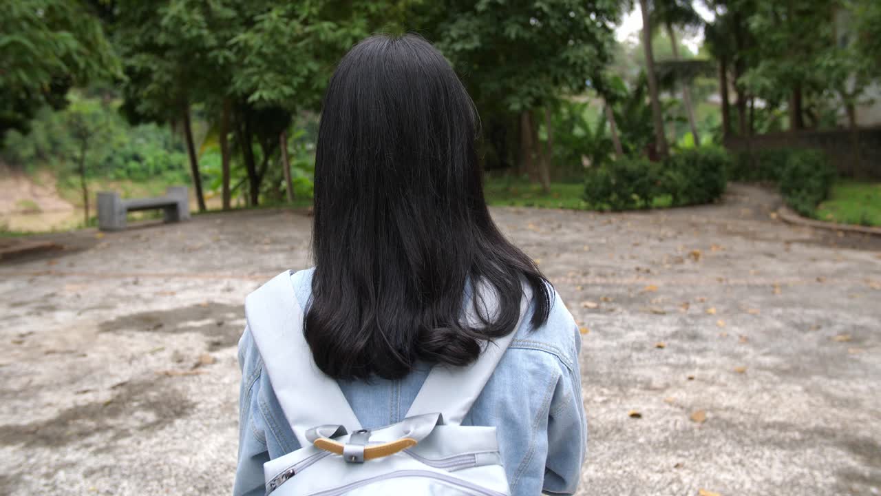 Woman with a Backpack in a Park