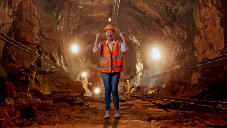 excited miner celebrating in underground tunnel