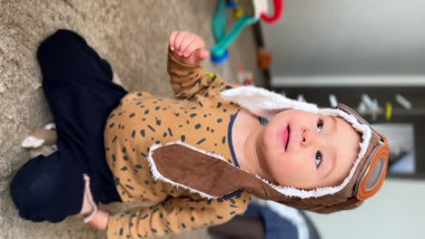 baby playing dressed as a pilot