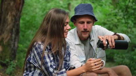 couple enjoying tea in the forest