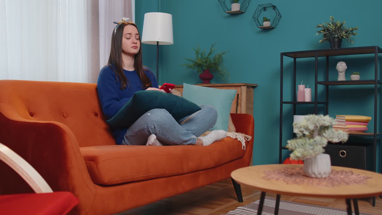 Sad young woman use mobile cell phone browsing loses becoming surprised sudden bad lottery results