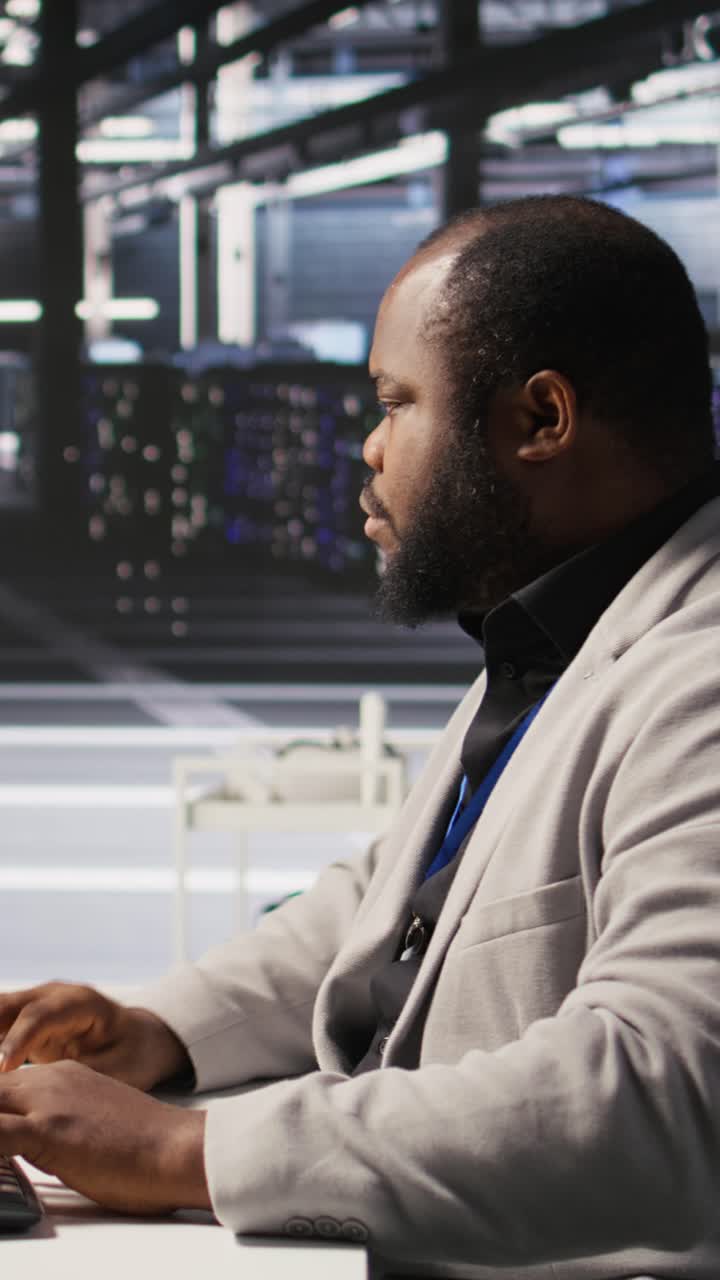 Vertical video Cheerful data center admin pleased after finalizing software upgrade