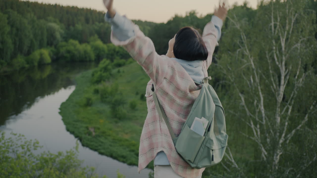 Woman enjoying nature with arms outstretched