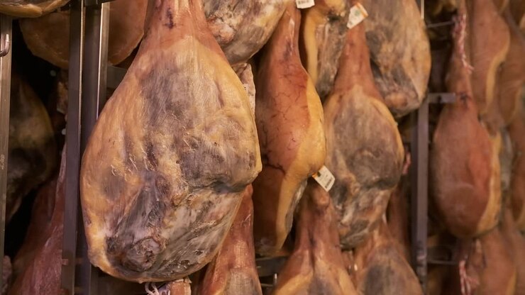 Jamon serrano pig legs factory hanging in a industry. Iberian ham elaboration process
