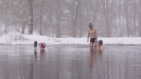 a male ice bather joins 2 women in an icy swedish lake