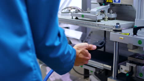 pharmaceutical worker cleaning pharmaceutical equipment with air under pressure