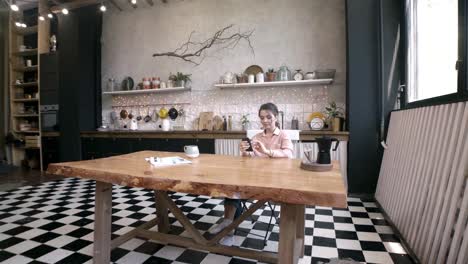 woman using smartphone in a modern kitchen