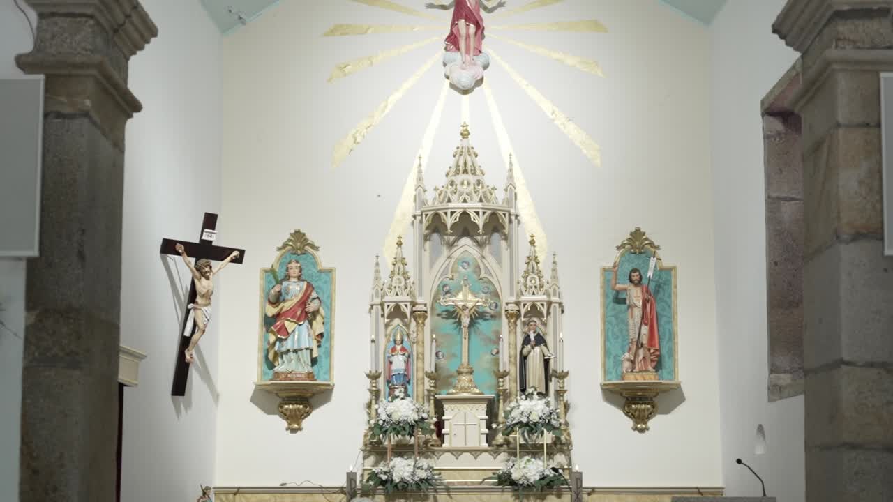bright altar with religious statues and crucifixion artwork in a catholic church interior