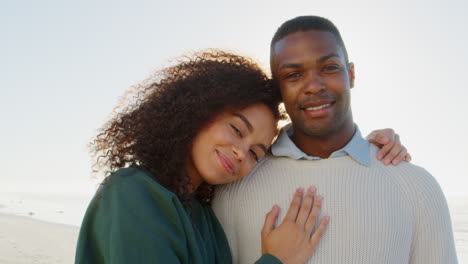 portrait of romantic couple on winter beach vacation with flare