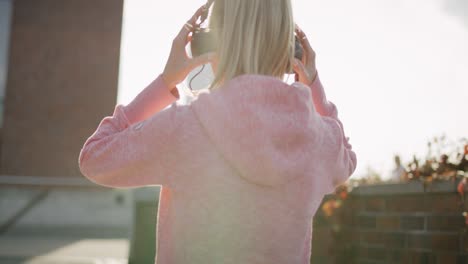 Handheld-view-of-woman-putting-on-headphones-before-jogging