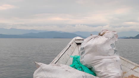 food supplies in burlap bags, delivered by traditional boat in africa