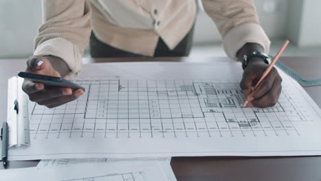 Hands-of-African-American-Architect-Drawing-Floor-Plan