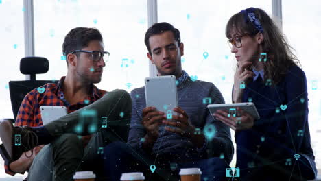 animation of network of digital icons against diverse group of colleagues discussing at office