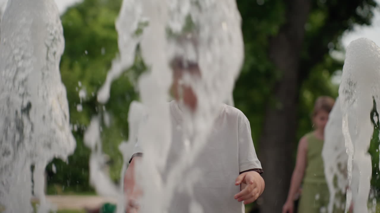 kid with face paint playing near water fountain, turns to playful run from water jets, summer park setting with blurred trees and people, sunlight glinting on droplets, carefree outdoors