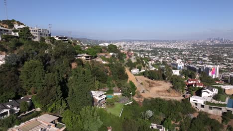 Hollywood-Hills-of-luxury-homes-of-celebrities,-iconic-aerial-views-above-Sunset-Blvd-of-Los-Angeles-landscape-during-the-day