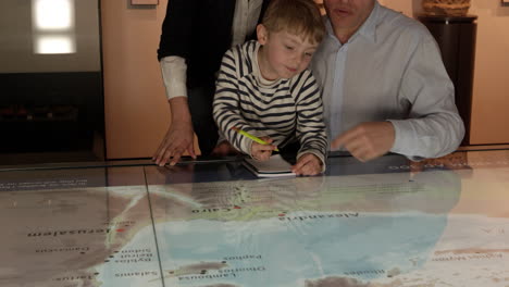 family on trip to museum looking at map shot on r3d