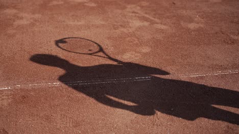 shadow silhouette tennis player bouncing ball on racket, used red play-court