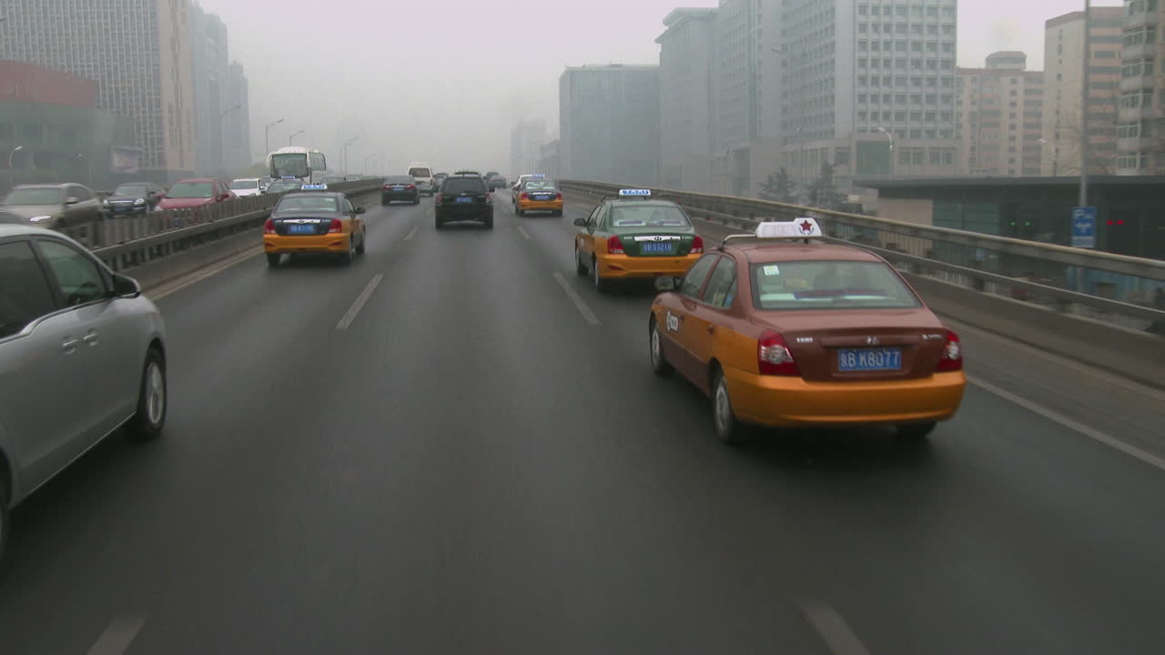 택시와 차량은 중국의 바쁜 도로를 따라 이동합니다.