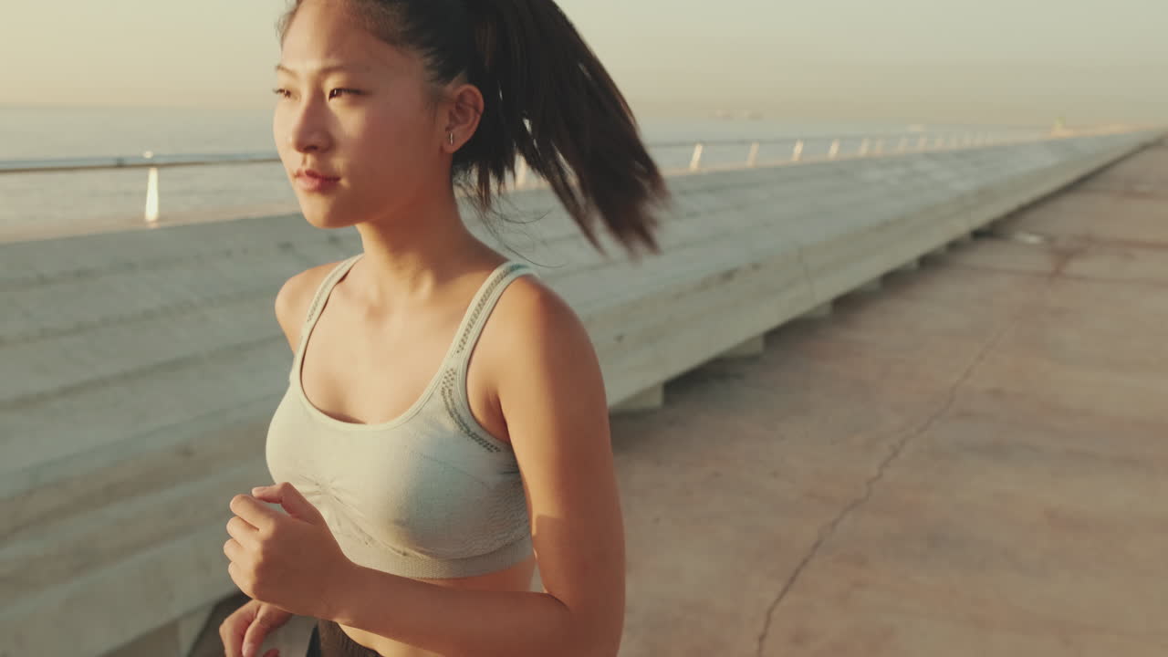 Woman running outdoors by the coastline