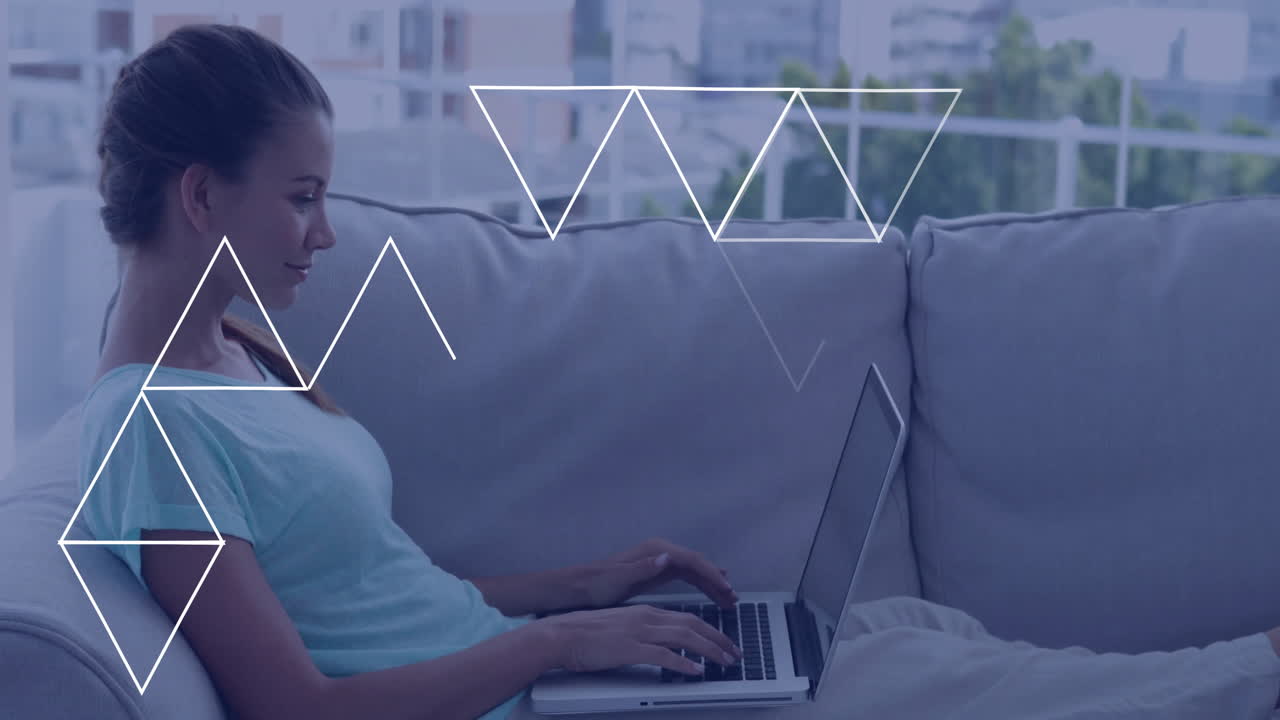 Using laptop on couch, woman with geometric shapes animation around her