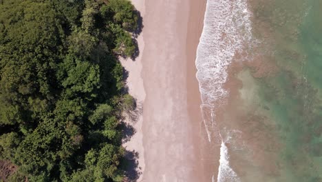 Cinematic-establishing-shot-of-an-empty-tropical-beach-in-central-America-with-turquoise-and-warm-pacific-waters