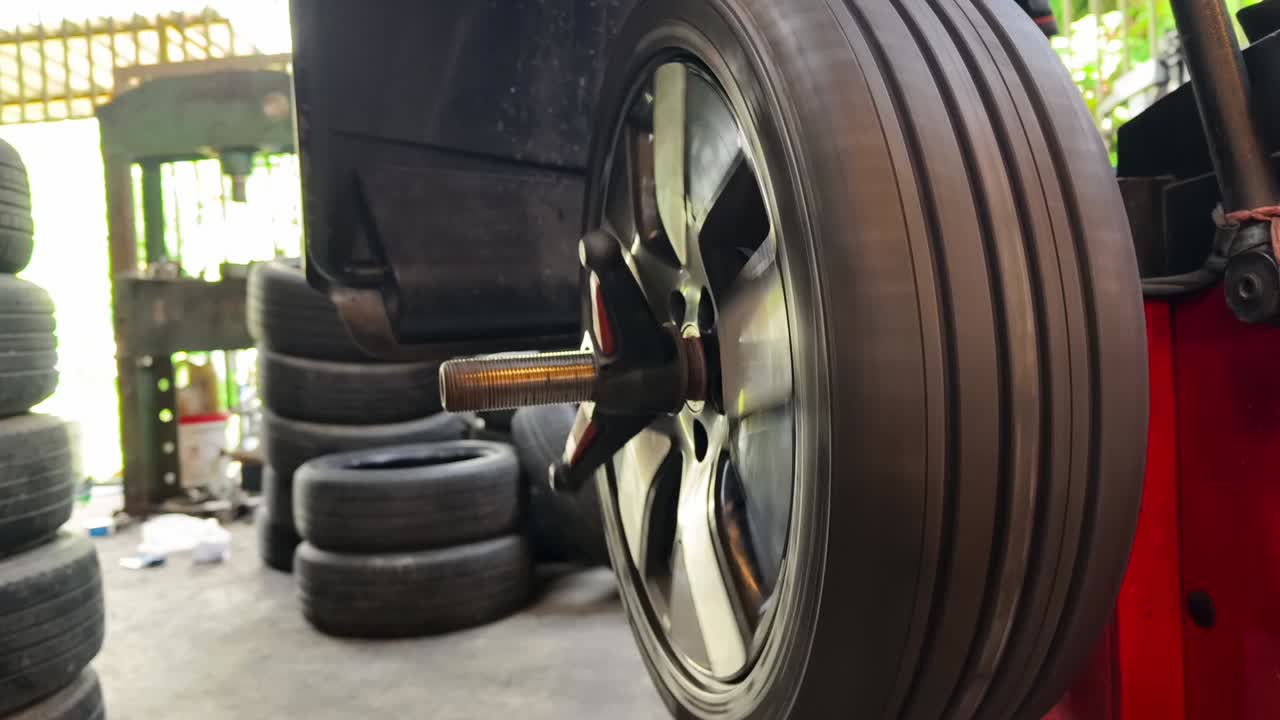 Car Wheel Balancing on a Machine in an Auto Repair Shop