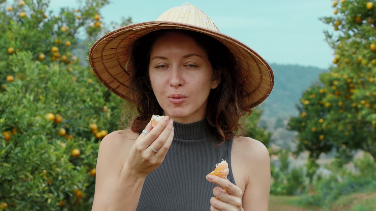 Woman Eating Oranges in an Orchard