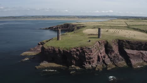 Aerial-orbits-nautical-marker-towers-on-Brownstown-Head-in-S-Ireland