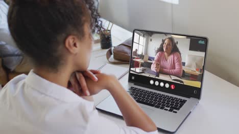 Animation-of-biracial-woman-having-video-call-on-laptop