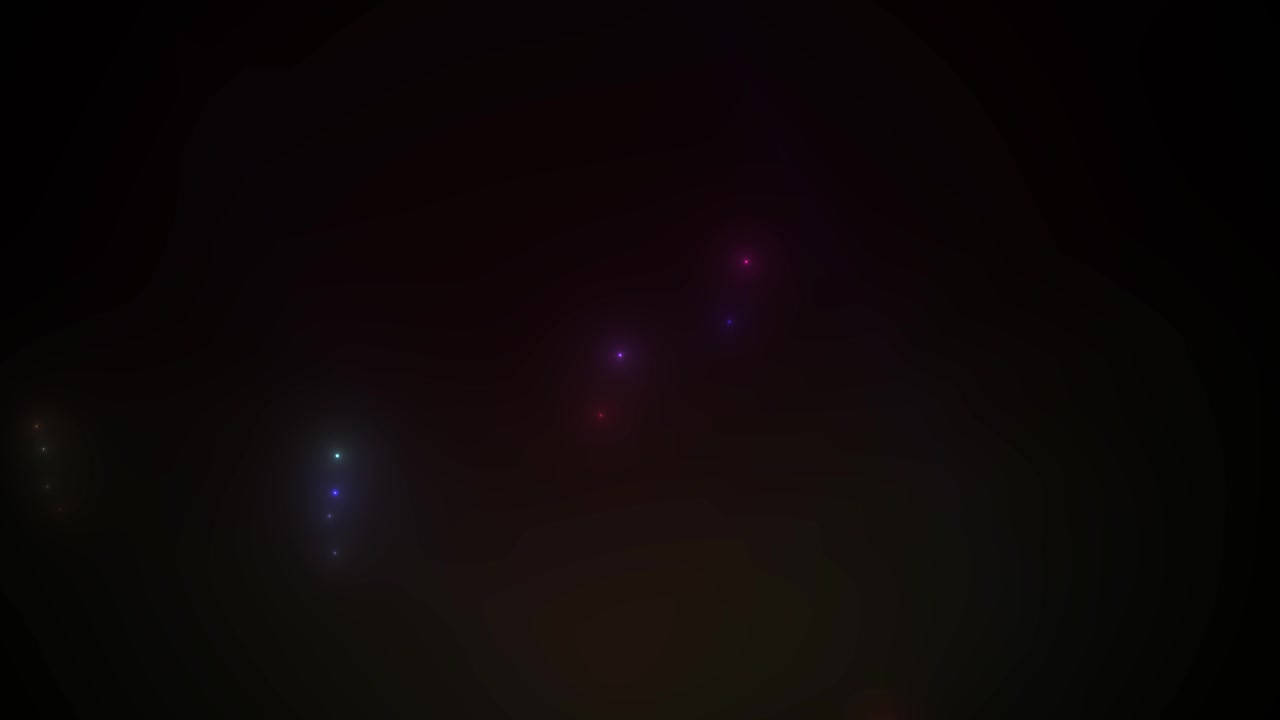 Particelle di luce colorate dinamiche che scintillano su sfondo nero