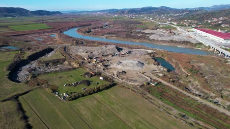 destroyed soil near river banks from sand quarry and industrial waste in central albania