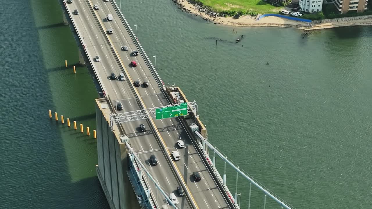 Traffic flows over a bridge in New York captured from a drone view