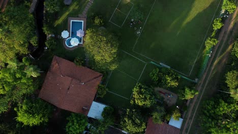 Orbit-Shot-Of-Beautiful-Rest-Cottage-House-With-Blue-Pool,-Paraguay