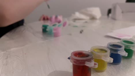 creative fun for the baby. painting at home. boy plays with creative painting of figures