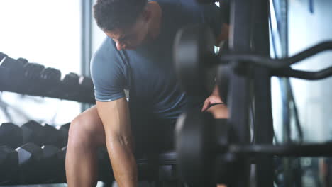 a fit young man working out with dumbbells